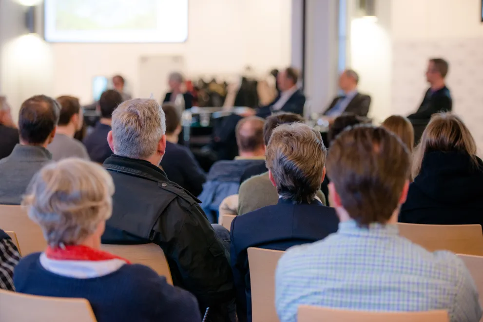 People in a conference room from behind
