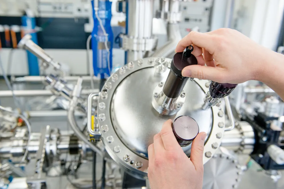 A person is handling a large measuring device.