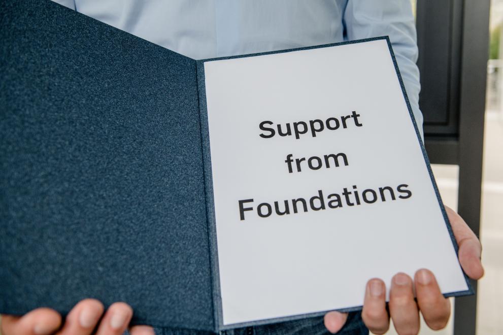 A folder with the inscription Support from Foundations